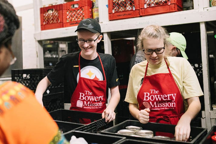 Volunteers wearing red aprons