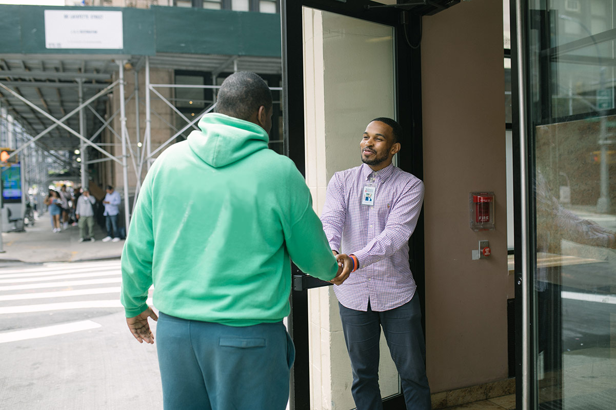 Guest being welcomed to The Bowery Mission