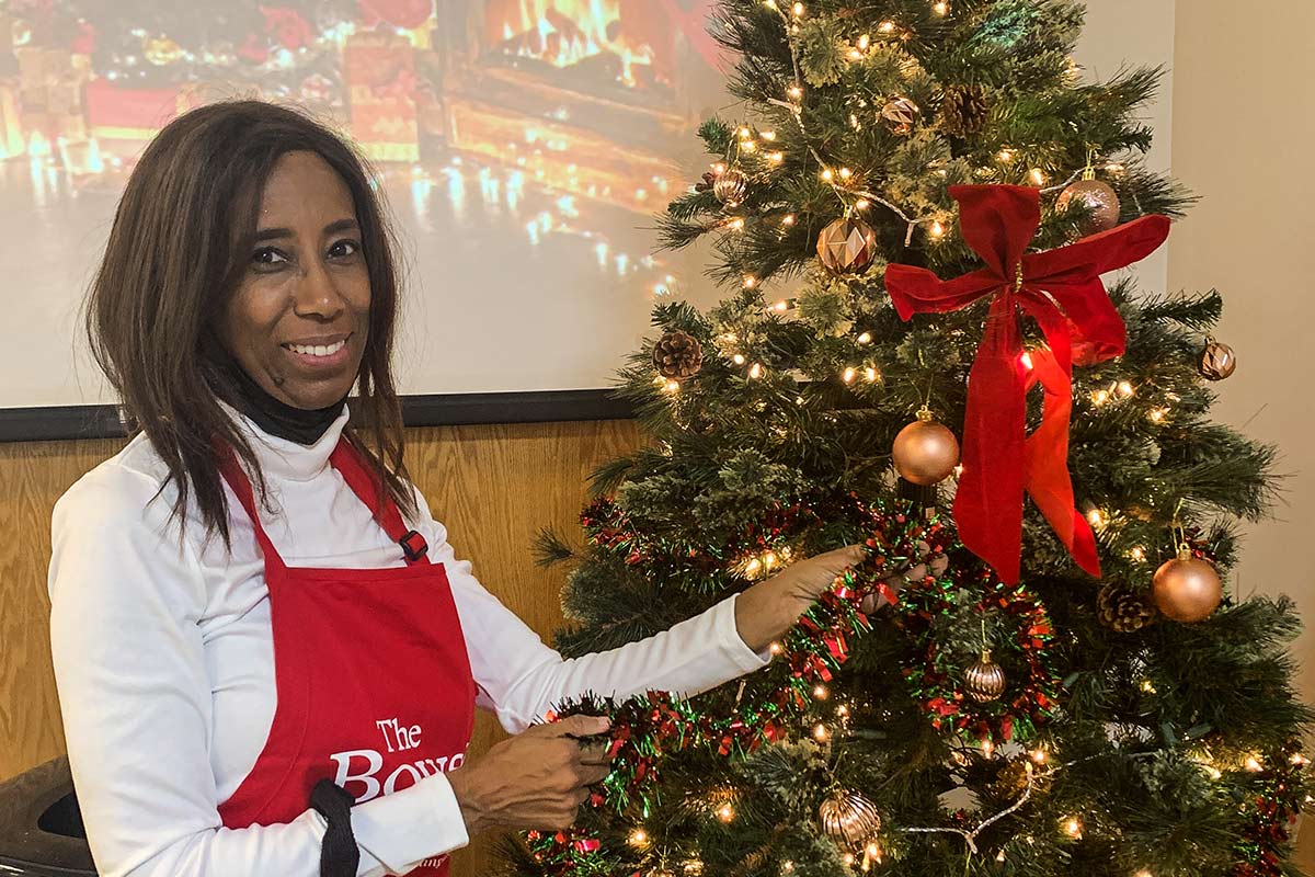 Volunteer decorating Christmas tree