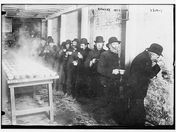 Men lined up to receive coffee at The Bowery Mission, circa 1900. From Library of Congress.