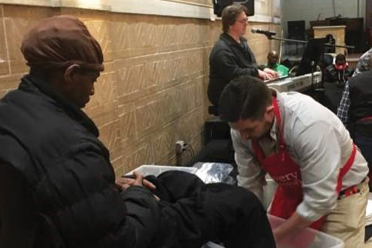 Staff washing guest feet.