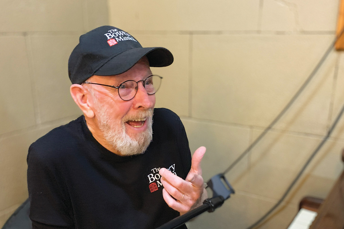 Bob, a volunteer, at the piano at The Bowery Mission