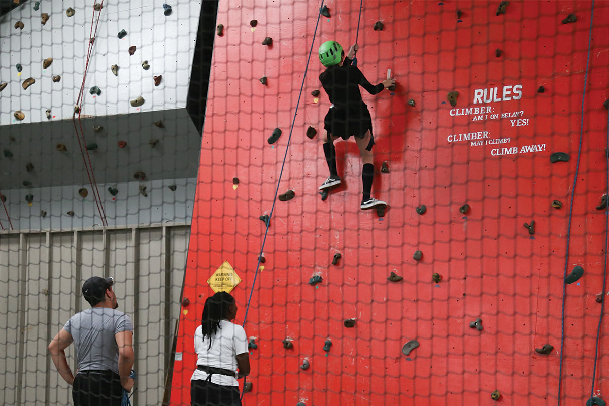 Camper climbing rock wall