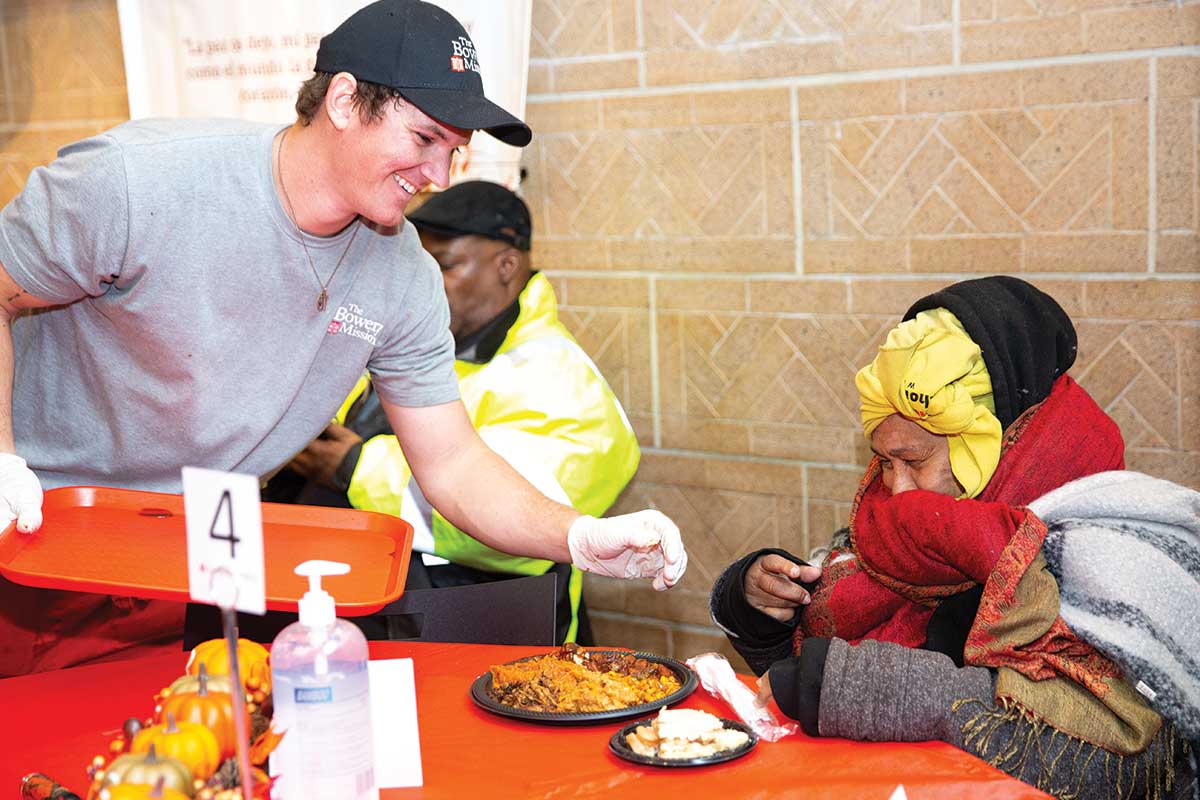 Volunteer serving Thanksgiving meal to guest