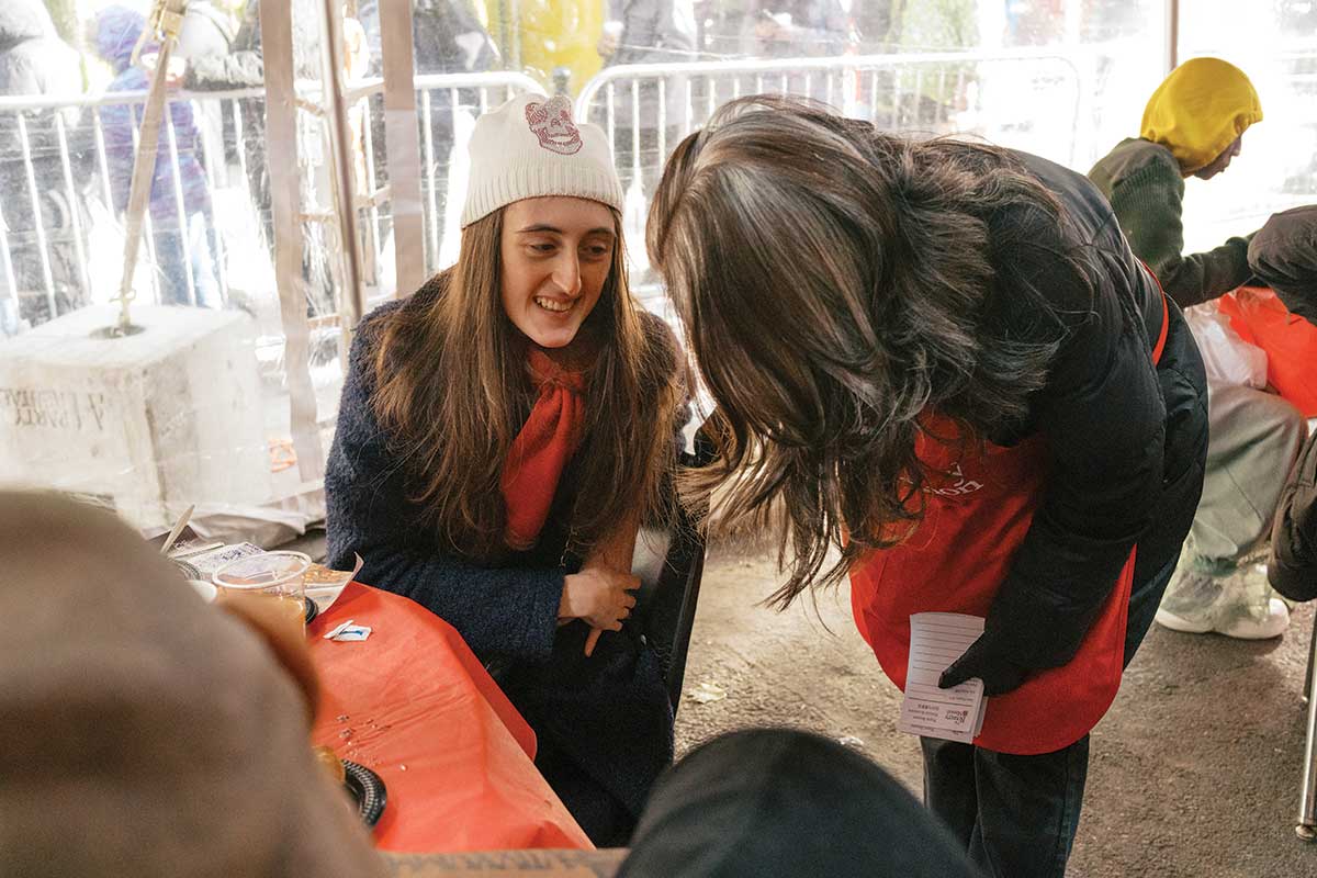 Volunteer speaking with Thanksgiving guest